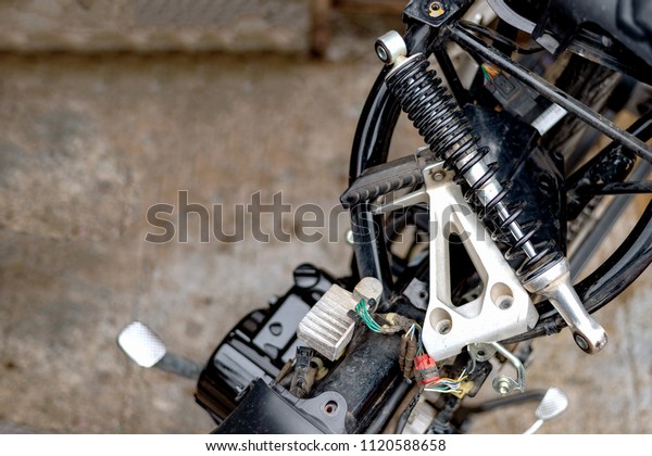 motorcycle repair with soft-focus and over\
light in the\
background