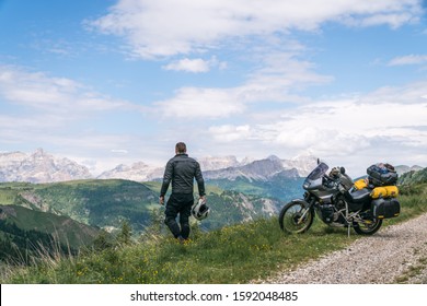 Motorcycle rider enjoy the momment. Touring adventure motorbike on the top of mountain, enduro, off road, beautiful view, danger road, freedom, extreme vacation. Passo Pordoi, Italy - Powered by Shutterstock