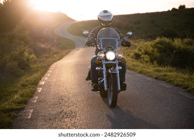 Motorcycle rider on the road in sunset light. Travel and sport, speed and freedom concept.