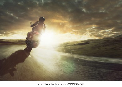 Motorcycle Rides Through A Curve At Sunset