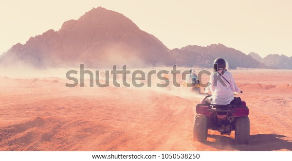 Motorcycle safari in sand desert Egypt. People\
riding travel. Beautiful holiday landscape. Extreme hobby games. \
Transport panorama. Amazing desert Sharm. Adventure Africa. Fun\
game.