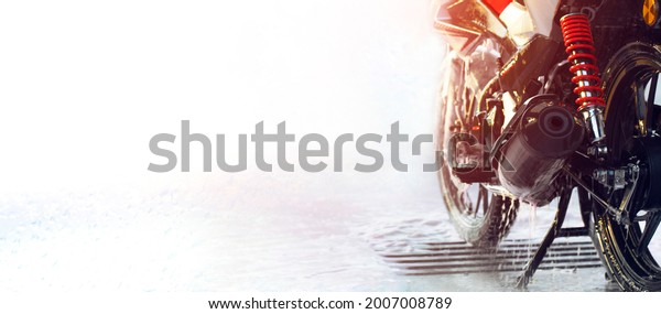 \
 \
Motorcycle at a self-service\
car wash. Banner, copy space, selective soft\
focus