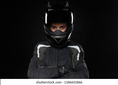 Motorcycle Sports, Extreme, Competition And Adrenaline. Active Young Female Racer Wearing Protective Helmet And Uniform Going To Participate In Road Racing Or Motorcross, Crossing Arms On Her Chest