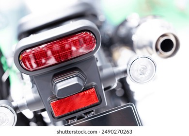 Motorcycle tail light. Red tail brake light. Motorcycle spare parts. Tail light cover when viewed from behind. - Powered by Shutterstock