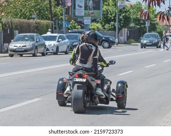 Motorcycle With Three Wheels - Trikes - In Traffic (two Wheels In Front And One Wheel In The Back). There Are Two People On The Motorcycle. Romania, Gorj. May, 22, 2022