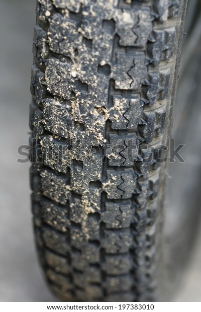 motorcycle tire with sand background, Close-up\
shot of classical motorcycle tire\
tread