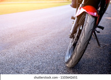 Motorcycle Tires Parked On The Street Near The Lawn