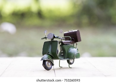 Motorcycle toy models on wooden floor with sunshine.