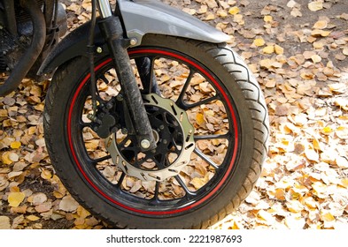 motorcycle wheel close-up on the background of autumn fallen leaves. - Powered by Shutterstock