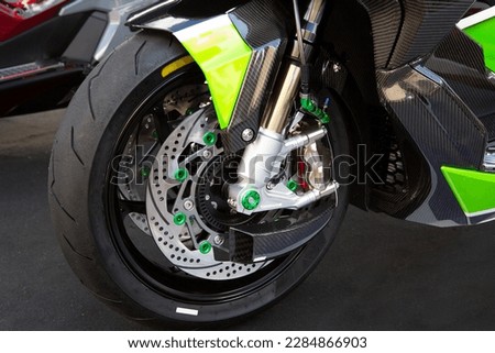 Motorcycle wheels with car accessories in showroom