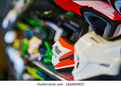 Motorcycles and accessories in modern motorcycle shop. Biker stuff. Helmets on wooden background. Selective focus.