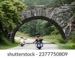 Motorcycles greet each other on Blue Ridge Parkway near an arch