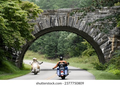 Motorcycles greet each other on Blue Ridge Parkway near an arch