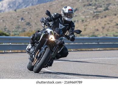 Motorcyclist Enjoying His Bike In The Corner. Photograph Taken In The Port Of Navalmoral, Avila, Spain, During The Month Of October 2021

