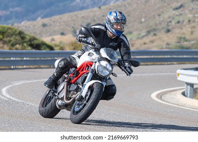 Motorcyclist Enjoying His Bike In The Corner. Photograph Taken In The Port Of Navalmoral, Avila, Spain, During The Month Of October 2021

