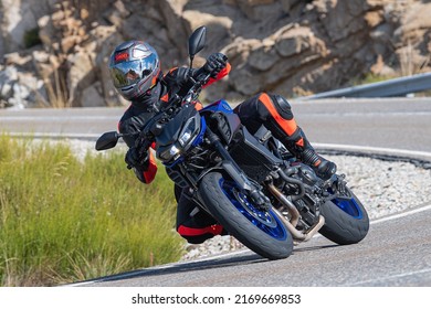 Motorcyclist Enjoying His Bike In The Corner. Photograph Taken In The Port Of Navalmoral, Avila, Spain, During The Month Of October 2021

