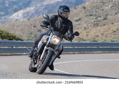 Motorcyclist Enjoying His Bike In The Corner. Photograph Taken In The Port Of Navalmoral, Avila, Spain, During The Month Of October 2021

