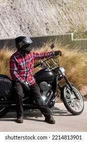 Motorcyclist Man Looking At The Horizon By His Motorcycle With Some Desert Behind