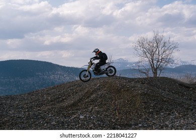 Motorcyclist Riding Off-road Dirt Motorcycle On Gravel Hills