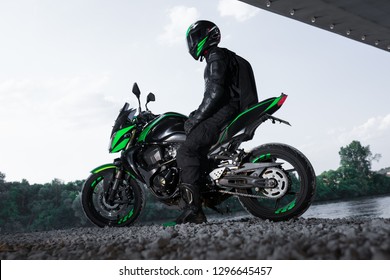 Motorcyclist Stop Under The Bridge Over The Road Waiting For Rain To Stop