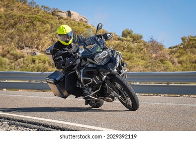 Motorcyclist taking a curve in the port of Navalmoral, Avila province, Spain, on November 20, 2020