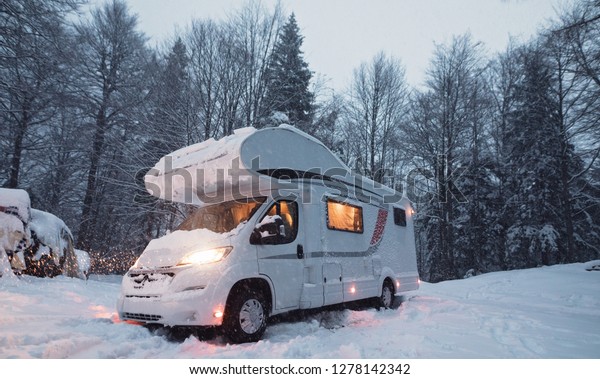 motorhome camper van in the nature, nomad van\
life for traveler in the winter\
holiday