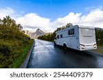 A motorhome parked by the road in the autumn landscape of Senja Island, Norway, with fjords and mountains.