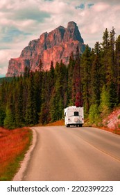 Motorhome RV Camper On Road In Forest Mountains