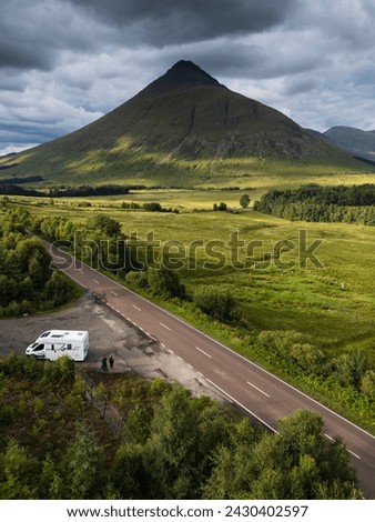 A motorhome with tourists travels on the A82 road as it passes Bridge of Orchy in the mountains of the Scottish highlands Stock photo © 
