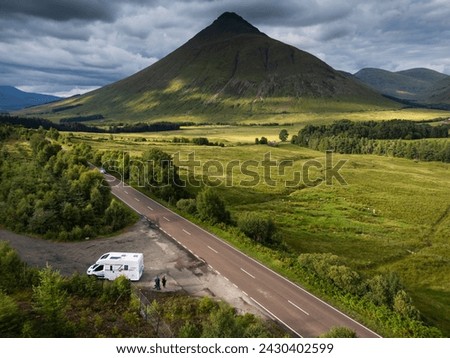 A motorhome with tourists travels on the A82 road as it passes Bridge of Orchy in the mountains of the Scottish highlands Stock photo © 