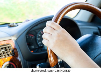 A motorist drives a car. Girl driving. Car dashboard. The driver is driving. Driving instruction to get a driver’s license. On a trip out of town. Safe driving. - Shutterstock ID 1569405829
