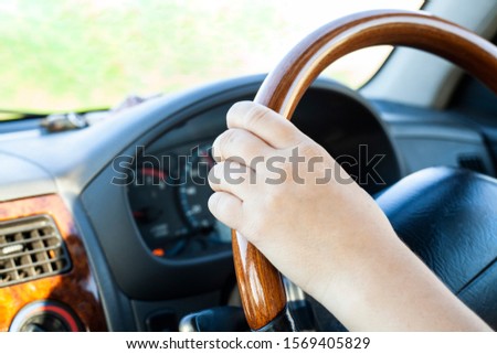 A motorist drives a car. Girl driving. Car dashboard. The driver is driving. Driving instruction to get a driver’s license. On a trip out of town. Safe driving.
