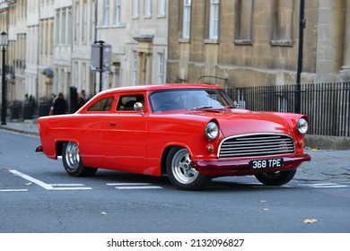  A Motorist Drives A Highly Modified Red Ford Mustang Classic Muscle Car On A City Centre Road On October 19, 2014 In Bath, UK. The Landmark City Receives Over 4 Million Visitors Each Year.