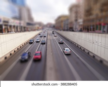 Motorway In Big City With Speedy Cars Motions By Tunnel - Tilt-shift Effect Used To Accent Motorway And To Emphasize The Speed Vision     