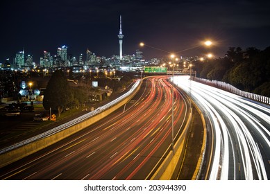 Motorway Car Trails With Auckland City Skyline 