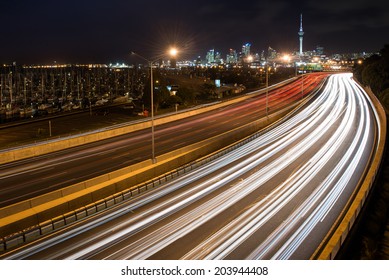 Motorway Car Trails With Auckland City Skyline 