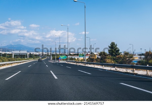 Motorway highway at the entrance to the city,\
asphalt road at the crossroads into the city, Thessaloniki, or\
Saloniki, Central Macedonia, Greece - Aug\
2021