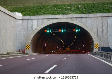 Motorway highway tunnel entrance,
traffic warning signs