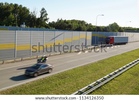 The motorway is protected against noise emission by noise-absorbing barrier (also called a soundwall, noise barrier, sound barrier) is an exterior structure designed to protection of people against no