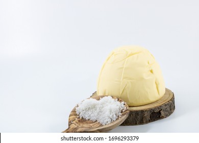 Motte salted butter churned the sea salt. on a wooden tray salt and a large wooden spoon Guérande photo studio on a white background - Shutterstock ID 1696293379