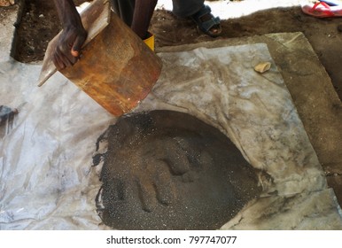 A Mould In Congolese Hand And Pile Of Finely Ground Coltan