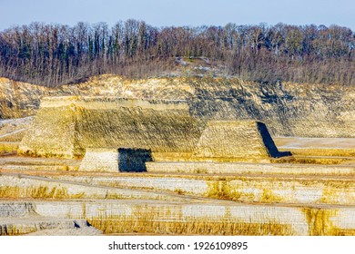 Mounds with a limestone stone hill with bare trees at the excavation site in the old marl mine at Sint-Pietersberg or Mount Saint Peter, part of the Caestert plateau in South Limburg, Netherlands - Shutterstock ID 1926109895