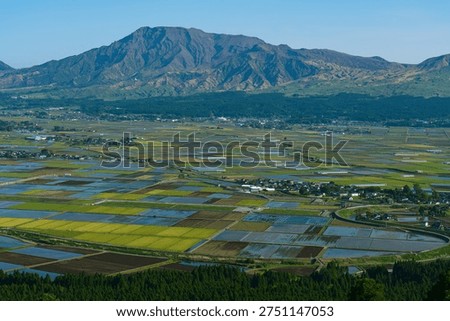 Mount Aso and Rice Fields View from Daikanbo, Kumamoto Japan Landscape. Panoramic view of Mount Aso, rice fields, and Aso city seen from Daikanbo viewpoint in Kumamoto, Japan. The wide caldera landscape and rural scenery highlight agriculture, nature, and travel destinations in Kyushu.