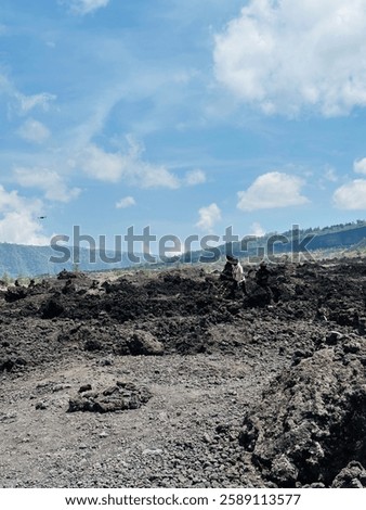 Mount Batur is an active volcano located at the center of two concentric calderas northwest of Mount Agung on the island of Bali, Indonesia.; black sand, Volcano Black Lava