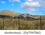 Mount behind wire fence in Portman bay