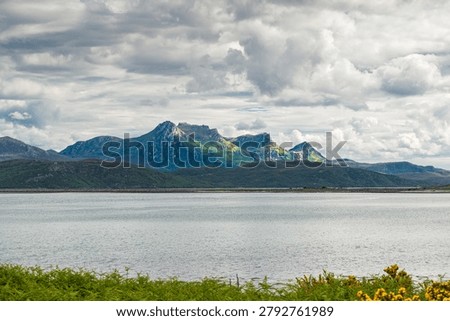 Mount Ben Loyal viewed from Kyle of Tongue Loch under a dramatic cloudy sky, Highlands, Scotland