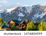 Mount Crested Butte Colorado village houses in summer with colorful sunset on green trees and lodging