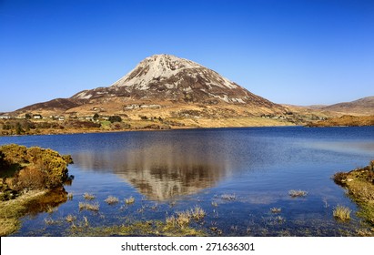 Mount Errigal, Co. Donegal, Ireland, Reflected In Blue Lake Surrounded By Peatland In National Park