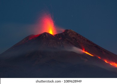 Mount Etna In Eruption With Lava Flow At Night. View From The Valle Del Bove
