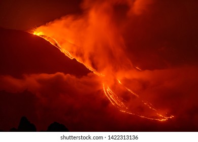 Mount Etna Eruption In Sicily, Lava Flows In The The Night In The Fog.